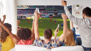 an image of a group of people watching fifa at home.