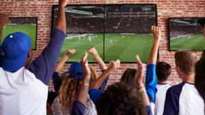 a group of friends watching FIFA in a sports bar