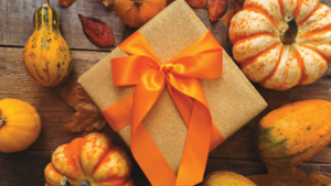 A gift box wrapped with orange ribbon