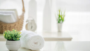 basket,towel & an artificial plant